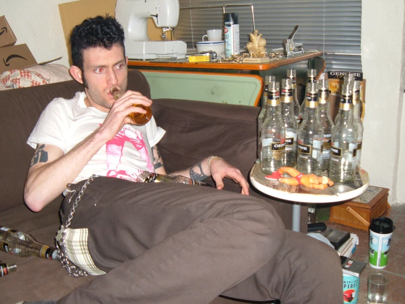 Josh surrounded by empty beer bottles.