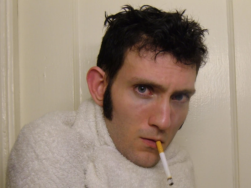 Josh wrapped in a towel looking scared.