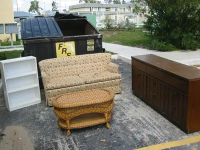 A room arranged outside by the dumpster.