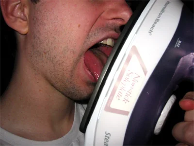 Kevin licks an iron, but it isn't plugged in.