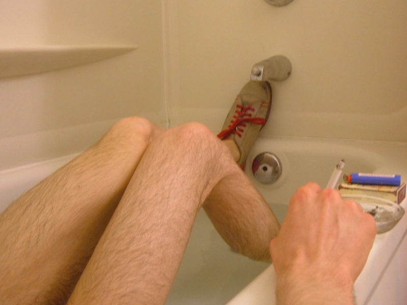 Josh takes a bath in bowling shoes.