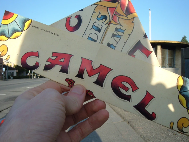 A paper hat made from a Camel advertisement.