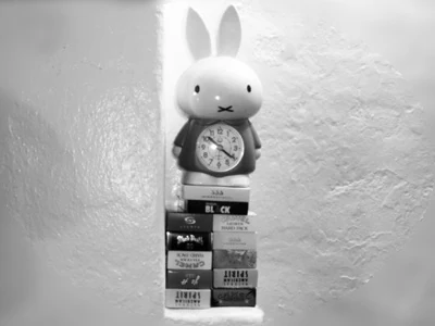 A rabbit clock sits atop a throne of cigarettes.