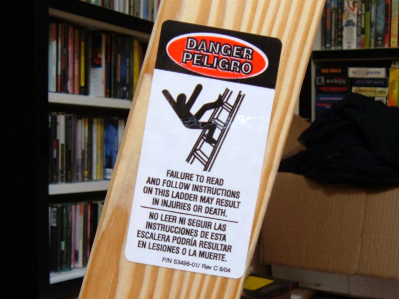 A step ladder with an amusing warning sticker.